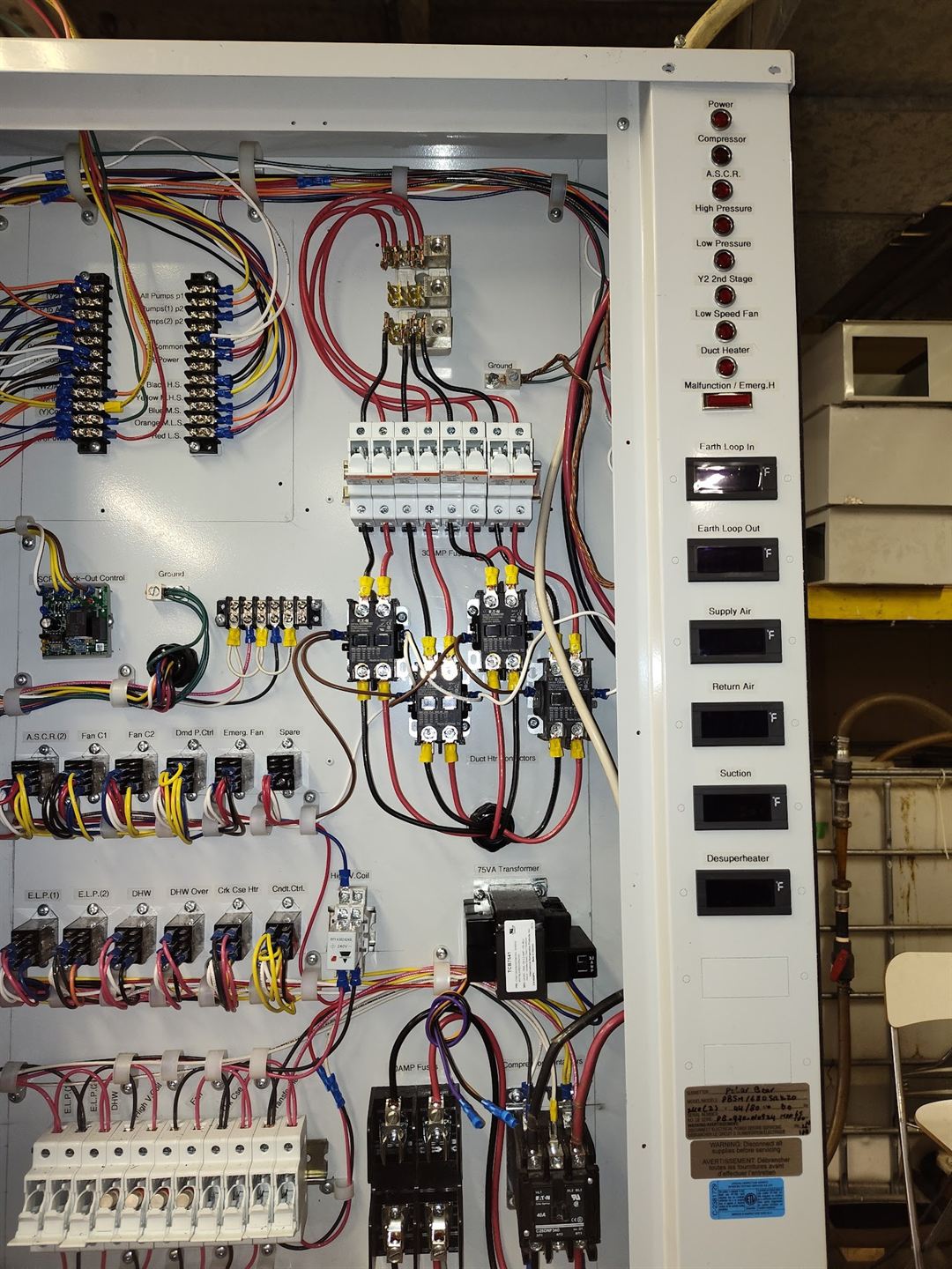 Open control cabinet with relays and terminal blocks