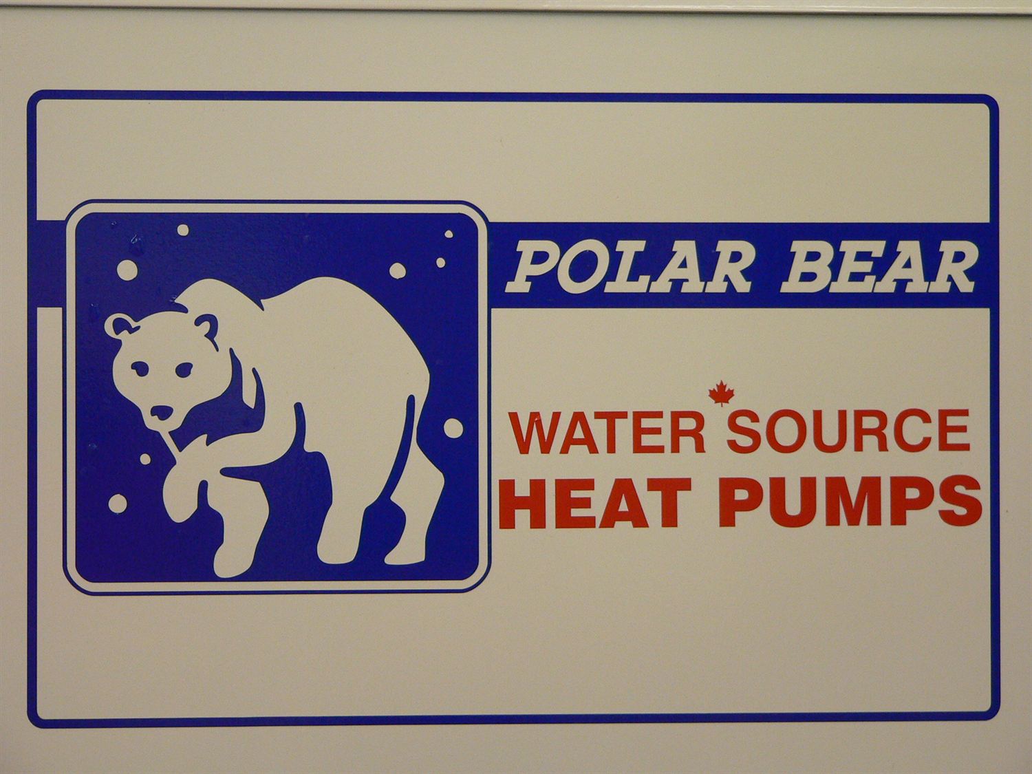 The Polar Bear Water Source Heat Pumps badge on a unit cabinet: a white polar bear on deep blue, with a red maple leaf.